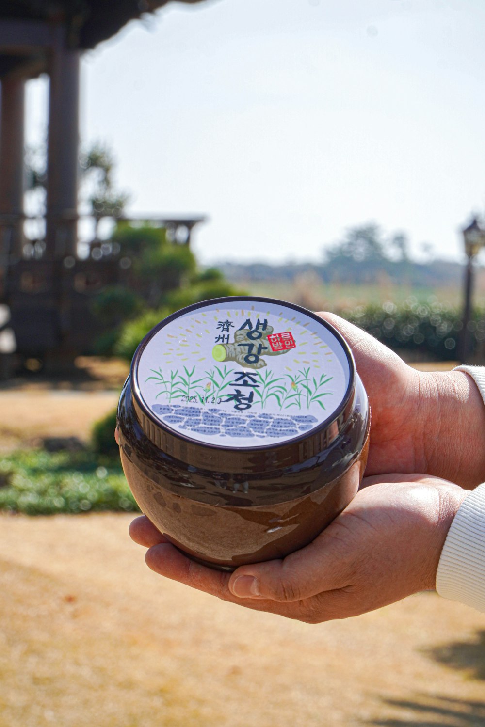 a person holding a jar of food in their hand