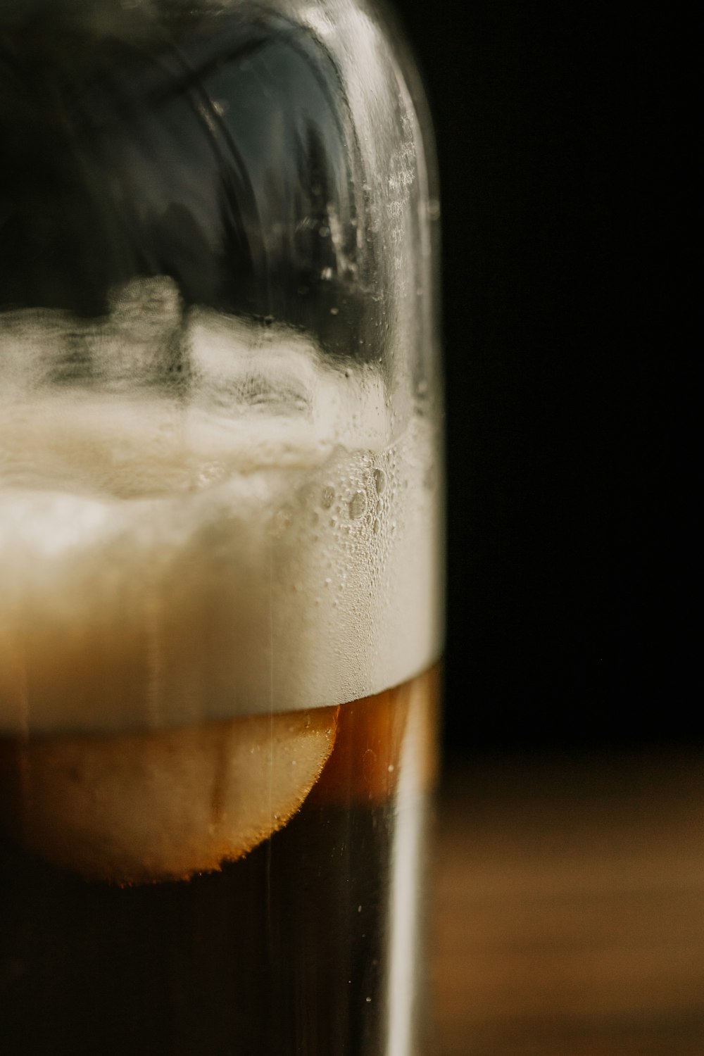 a close up of a glass of beer on a table