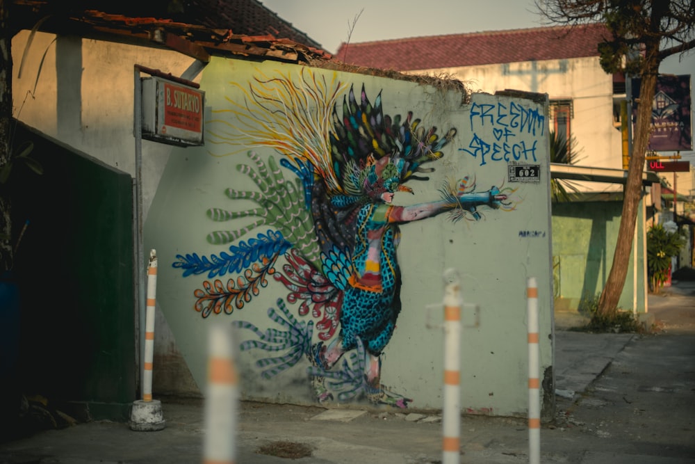 a mural of a peacock painted on the side of a building