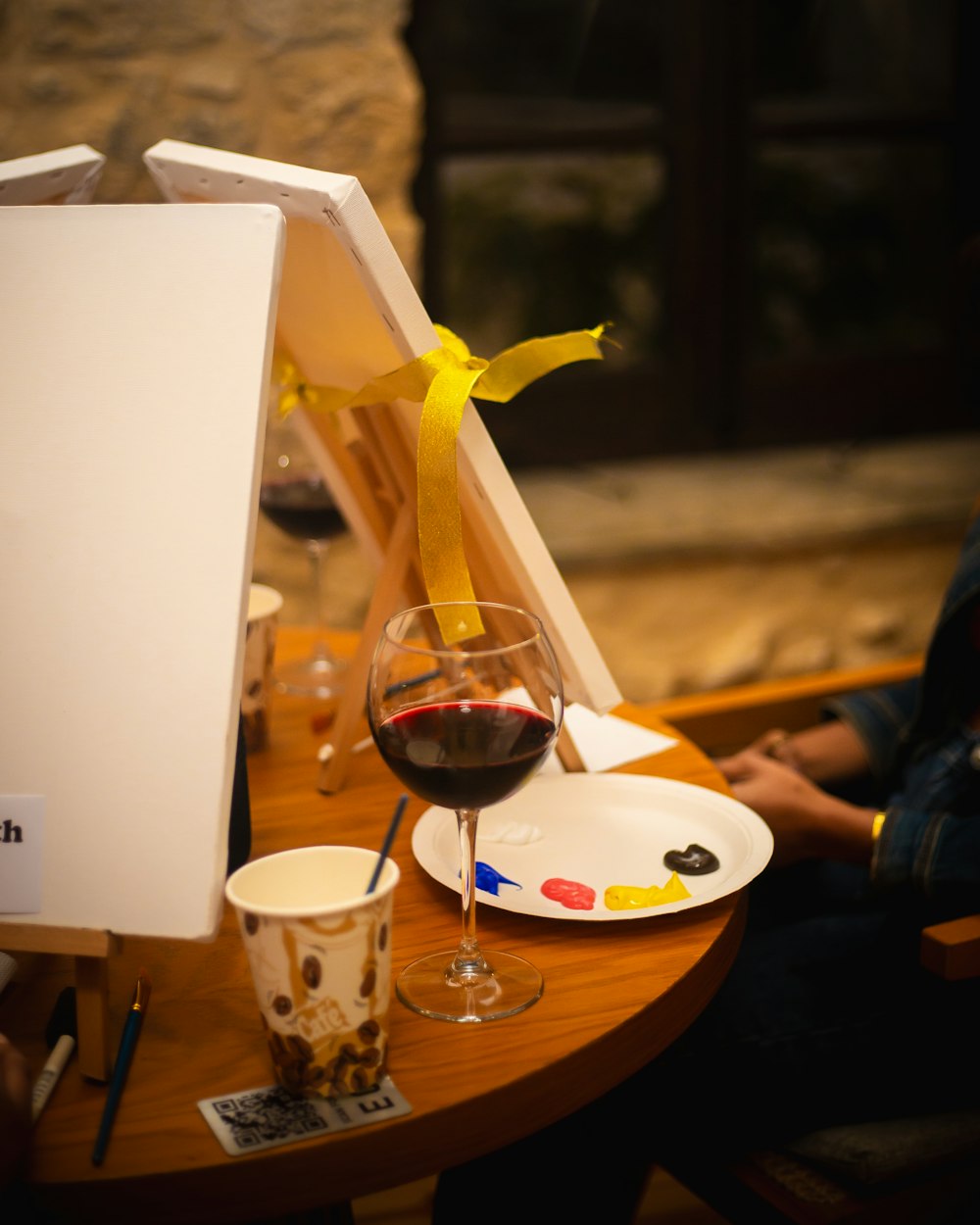 a glass of wine sitting on top of a wooden table