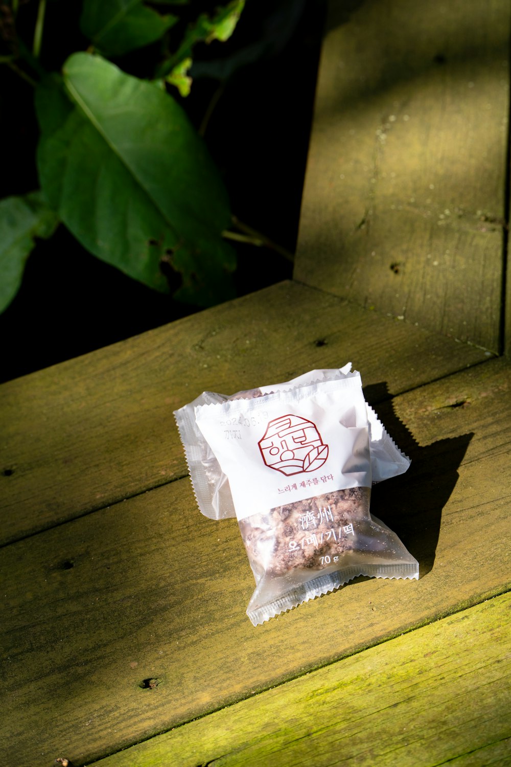 a bag of food sitting on top of a wooden bench