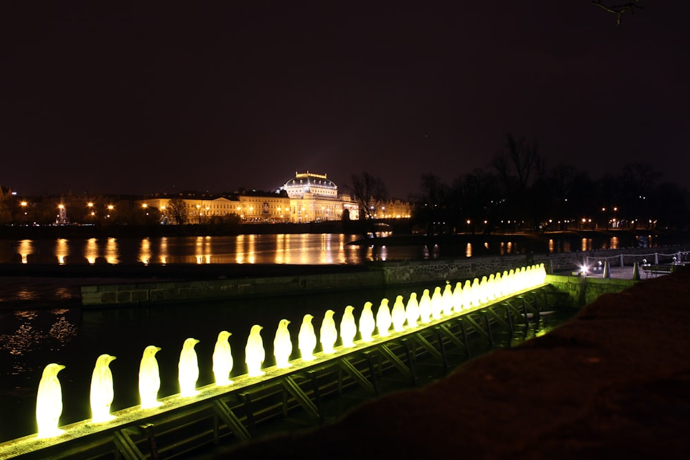 a large body of water at night with a castle in the background