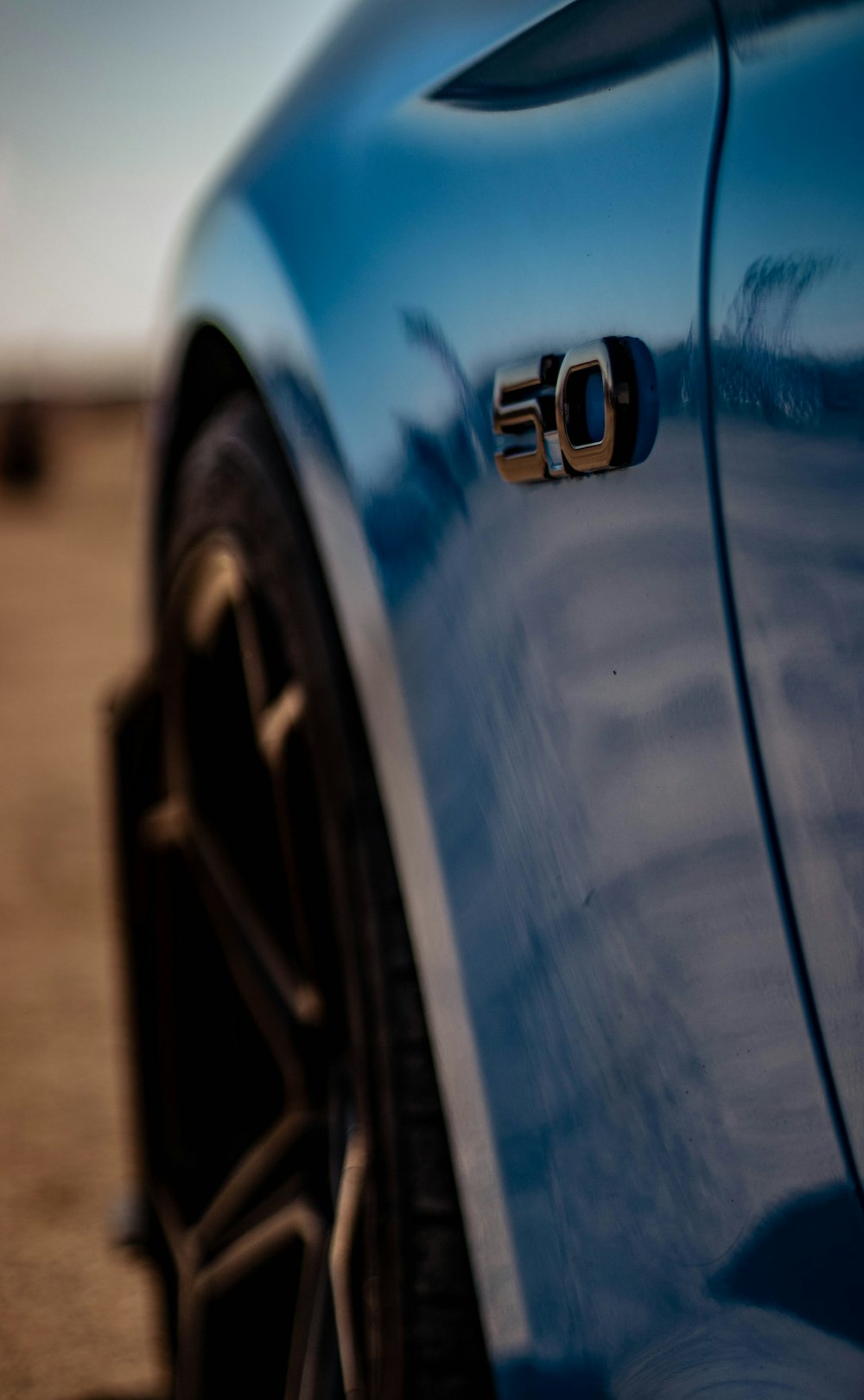 a close up of a blue sports car