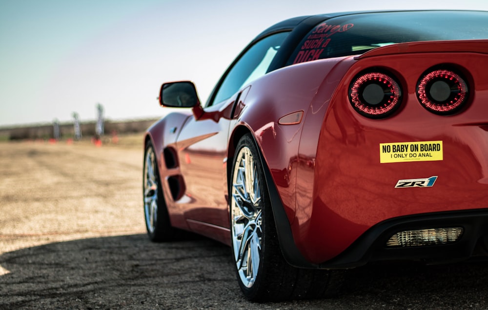 a red sports car parked on the side of the road