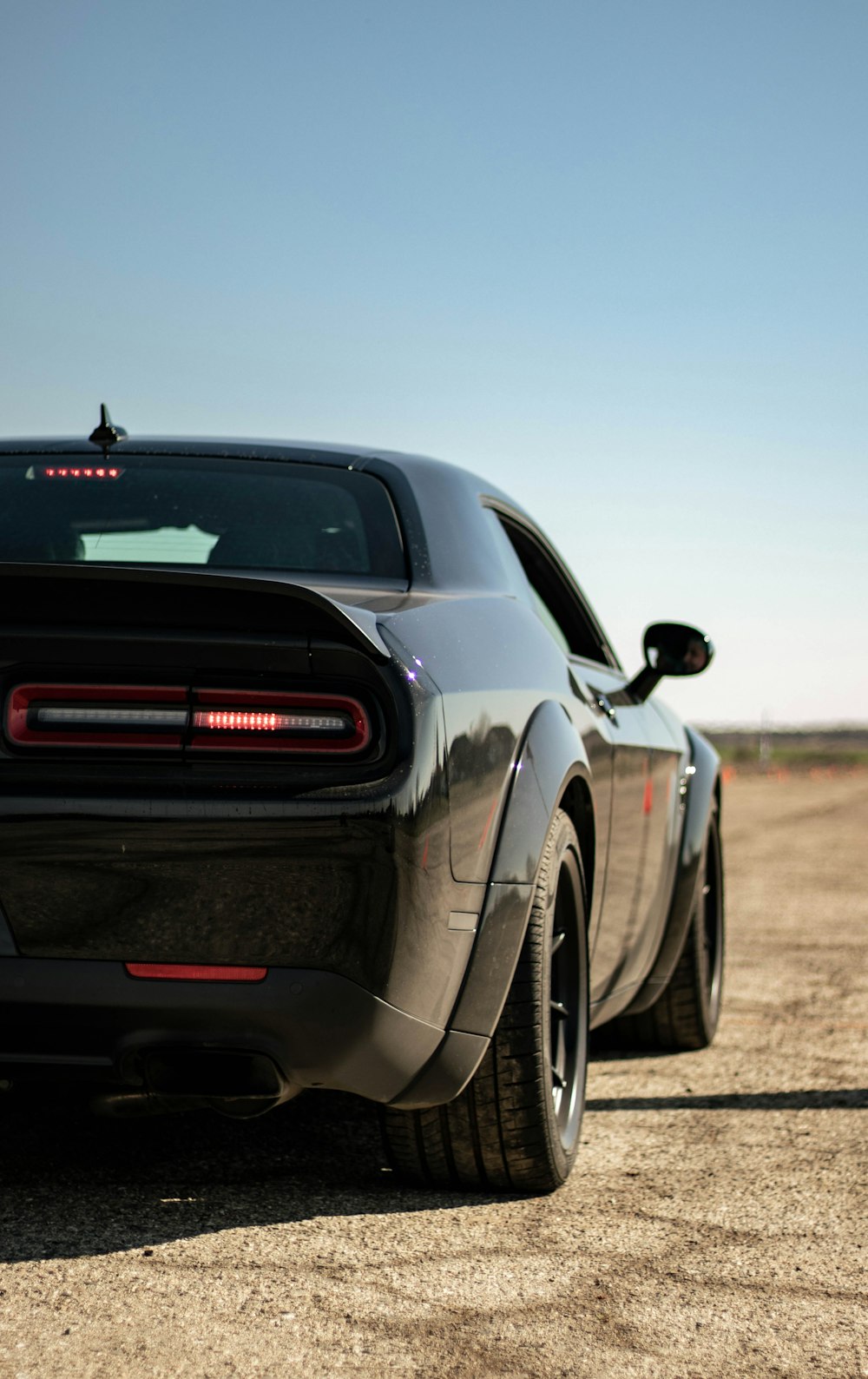 the rear end of a black sports car