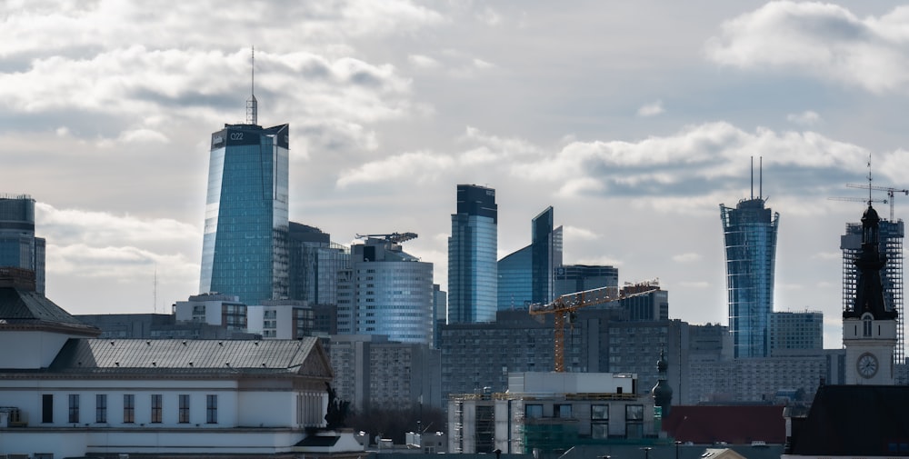a city with tall buildings and a crane in the foreground