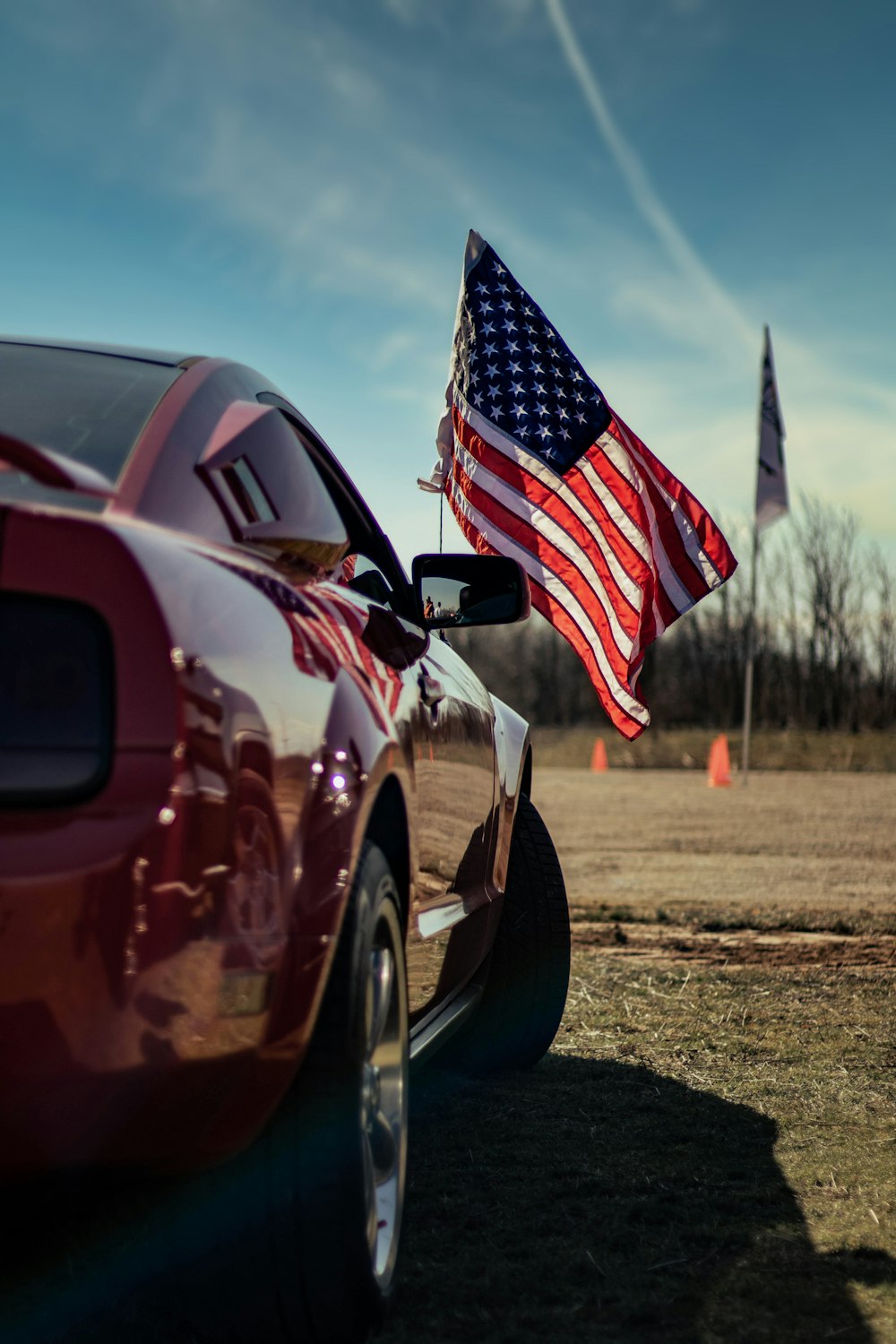 a red car with an american flag on top of it