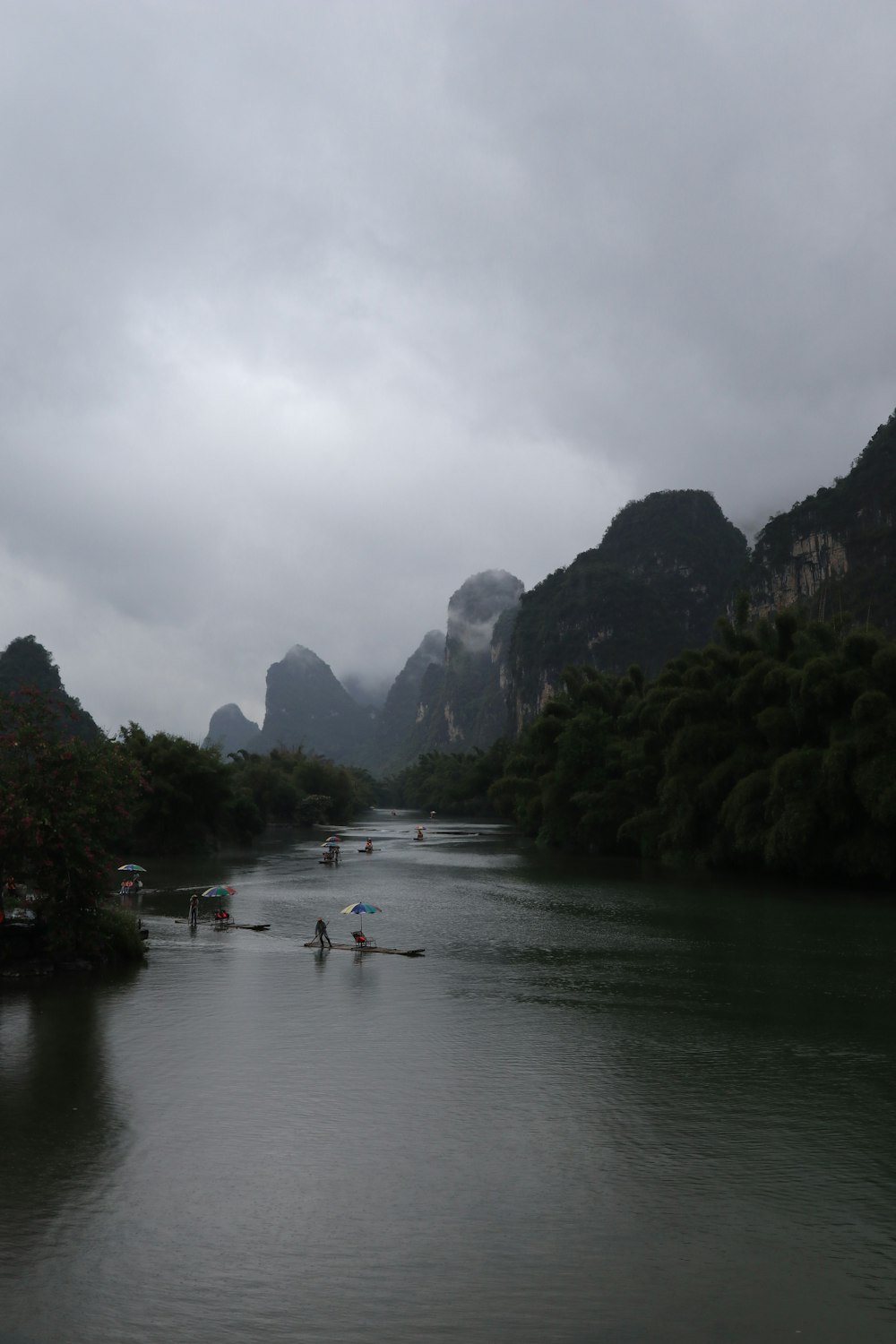 a group of people rowing a boat down a river