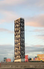 a tall building with a lot of people on it