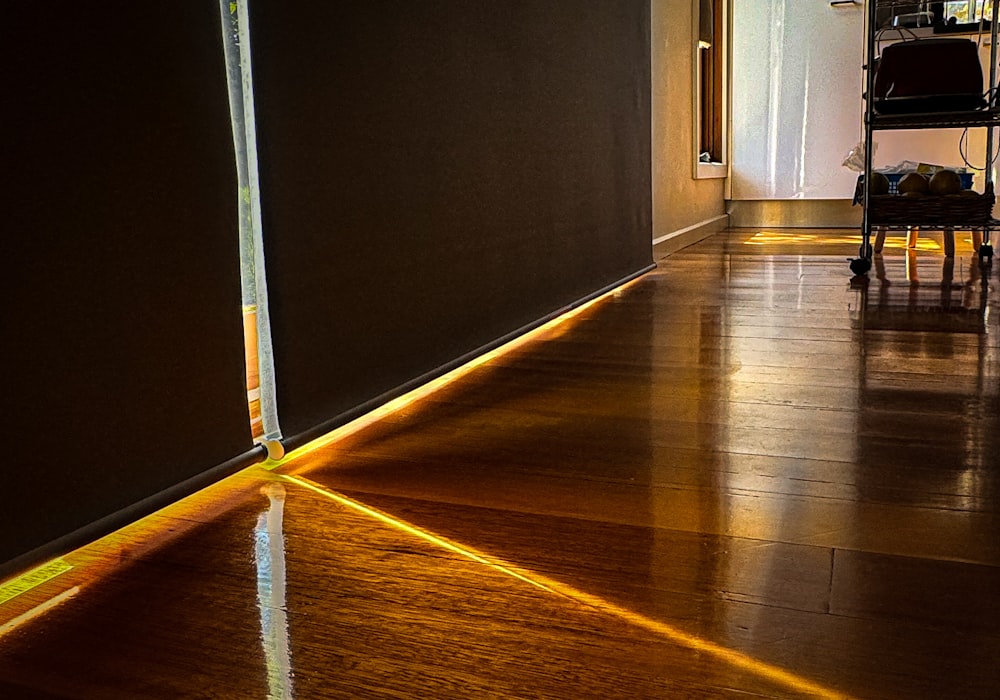 a wooden floor with a light shining on it