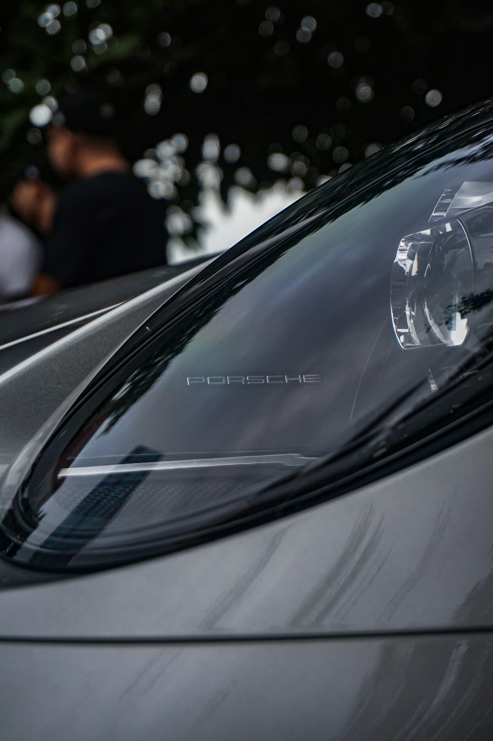 a close up of a car with a person in the background