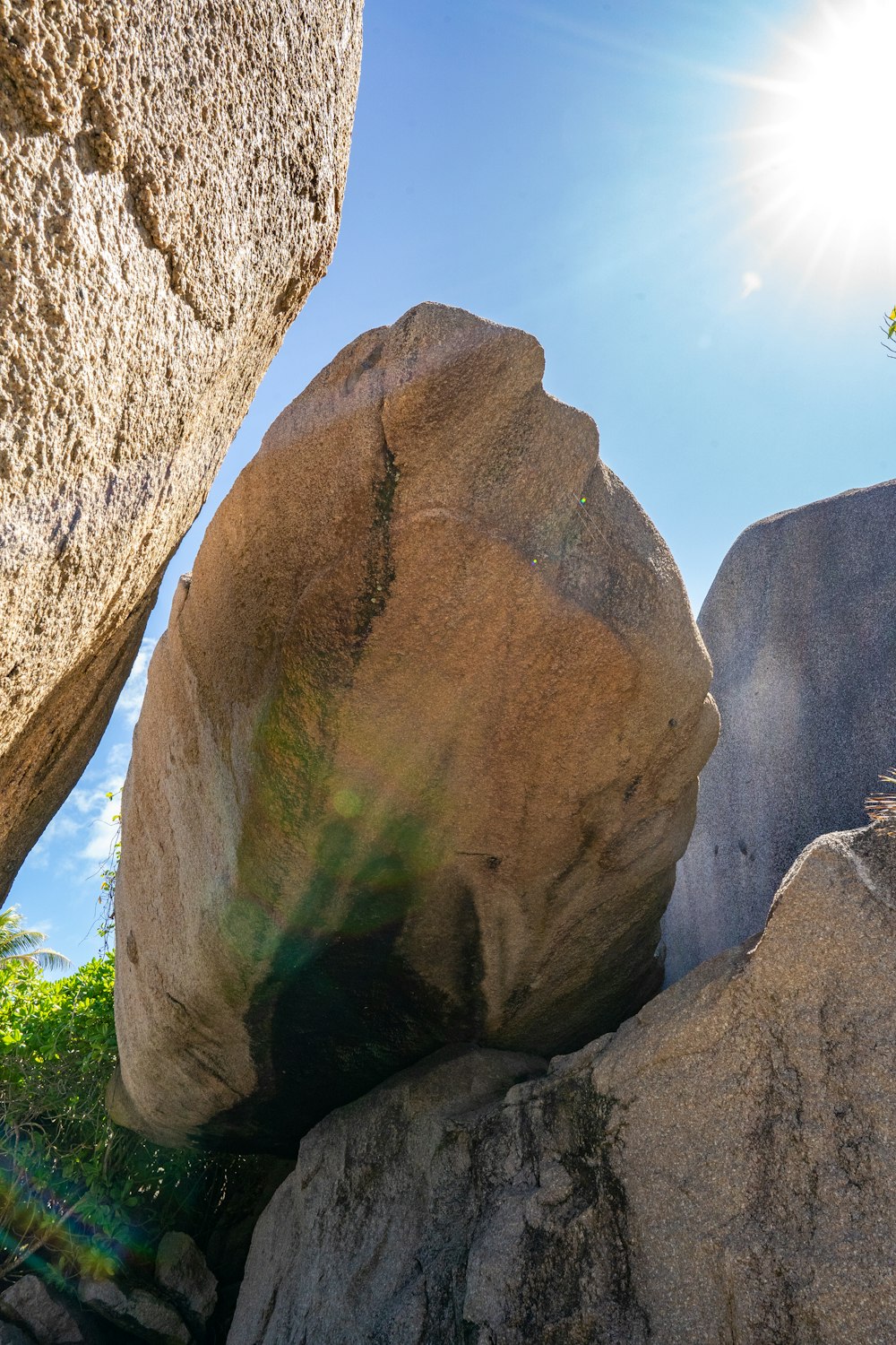 a large rock sitting between two large rocks