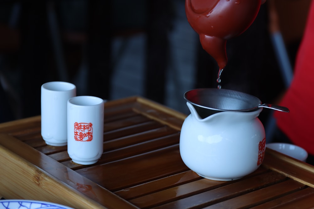 a person pours tea into a tea pot