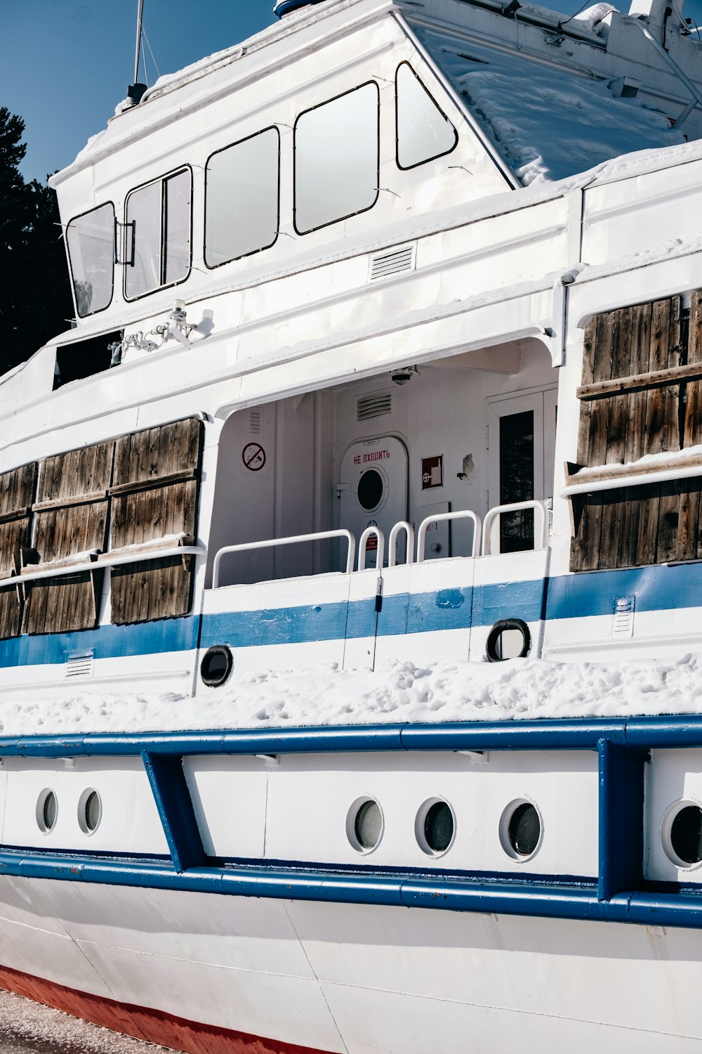 a white and blue boat docked at a dock