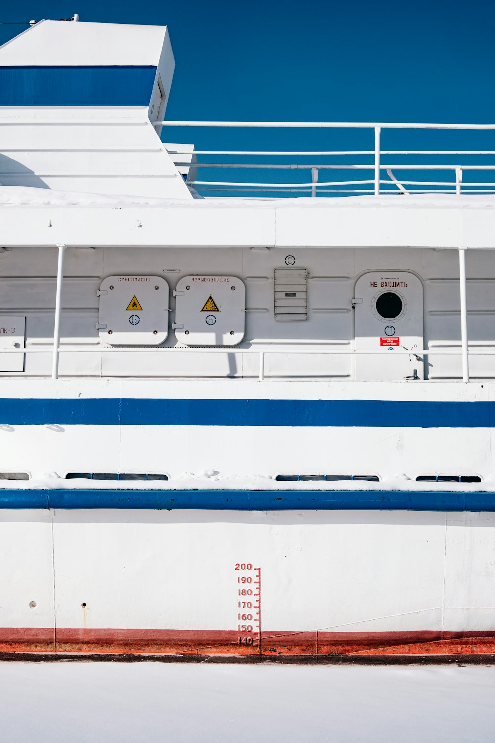 a large white and blue boat on a body of water