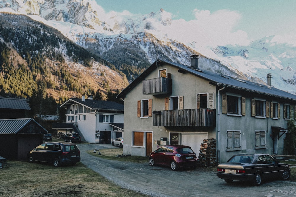 a couple of cars parked in front of a building