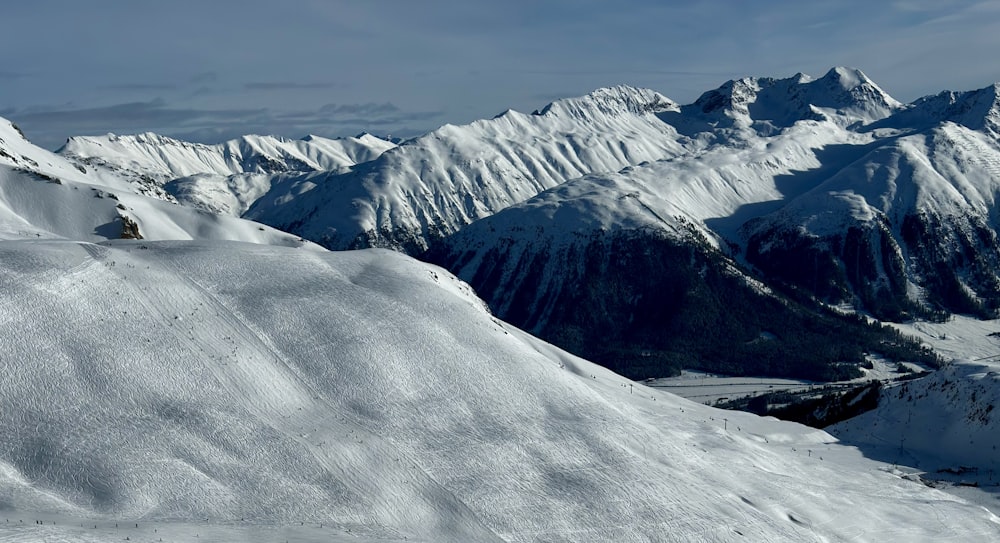 a snowboarder is going down a snowy mountain