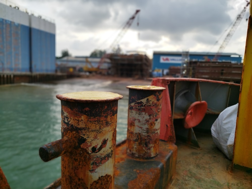 rusted pipes on the side of a boat in the water