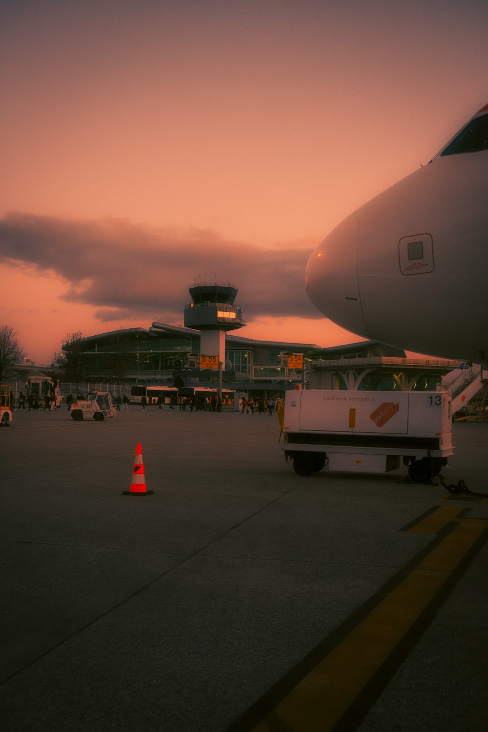 an airplane parked on the tarmac at sunset