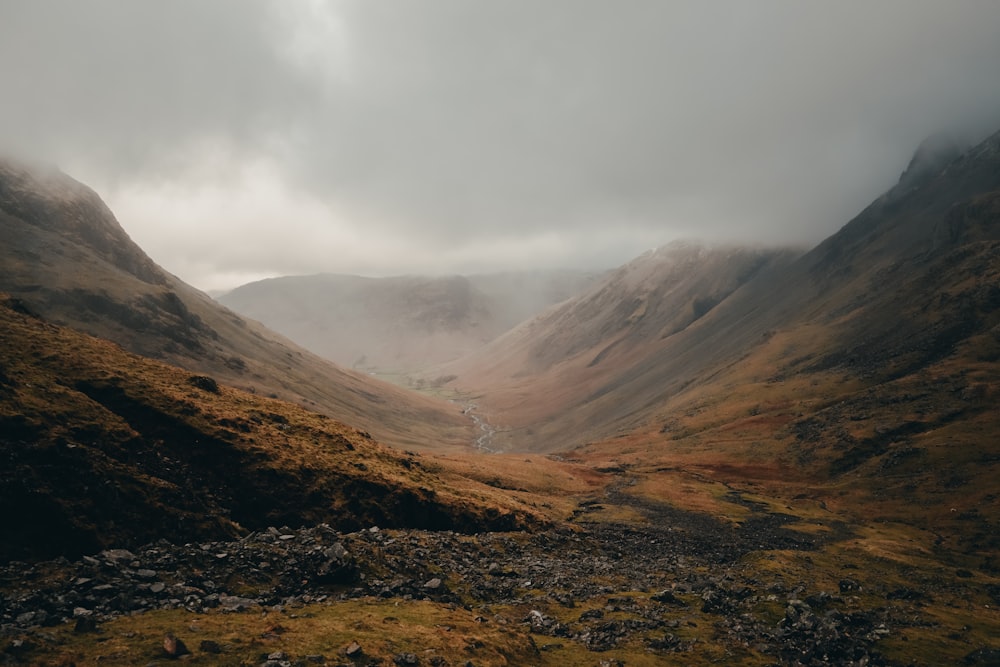 a view of a valley with mountains in the background