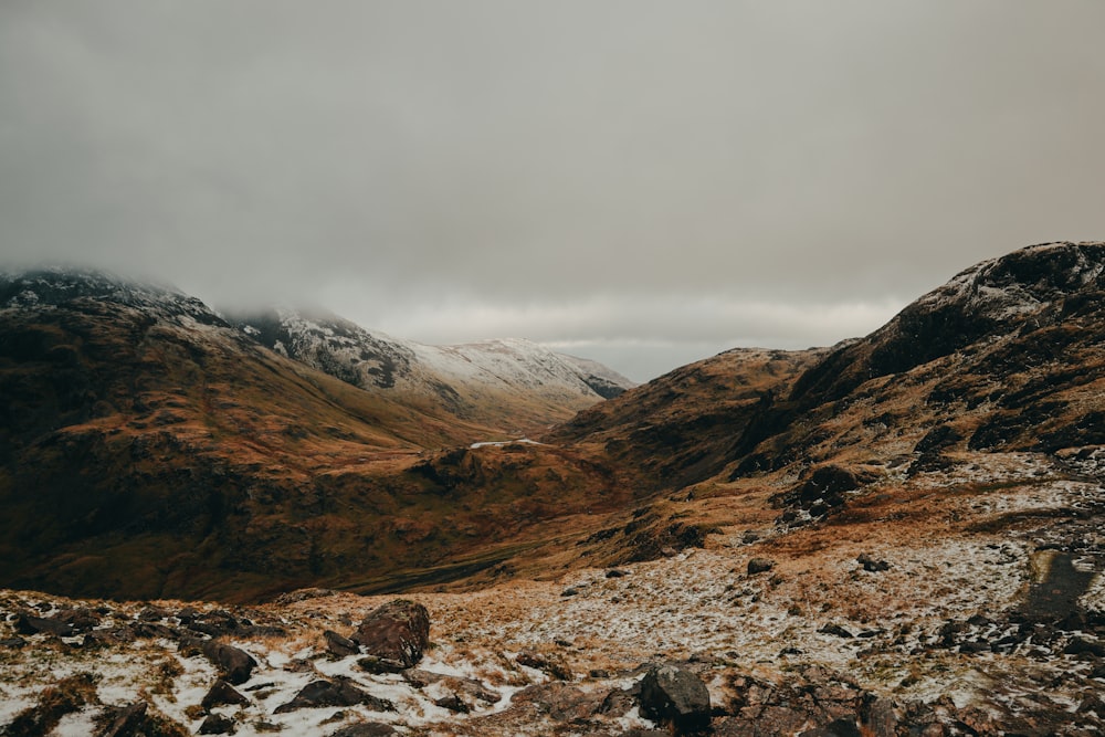 a view of a mountain range with snow on the ground