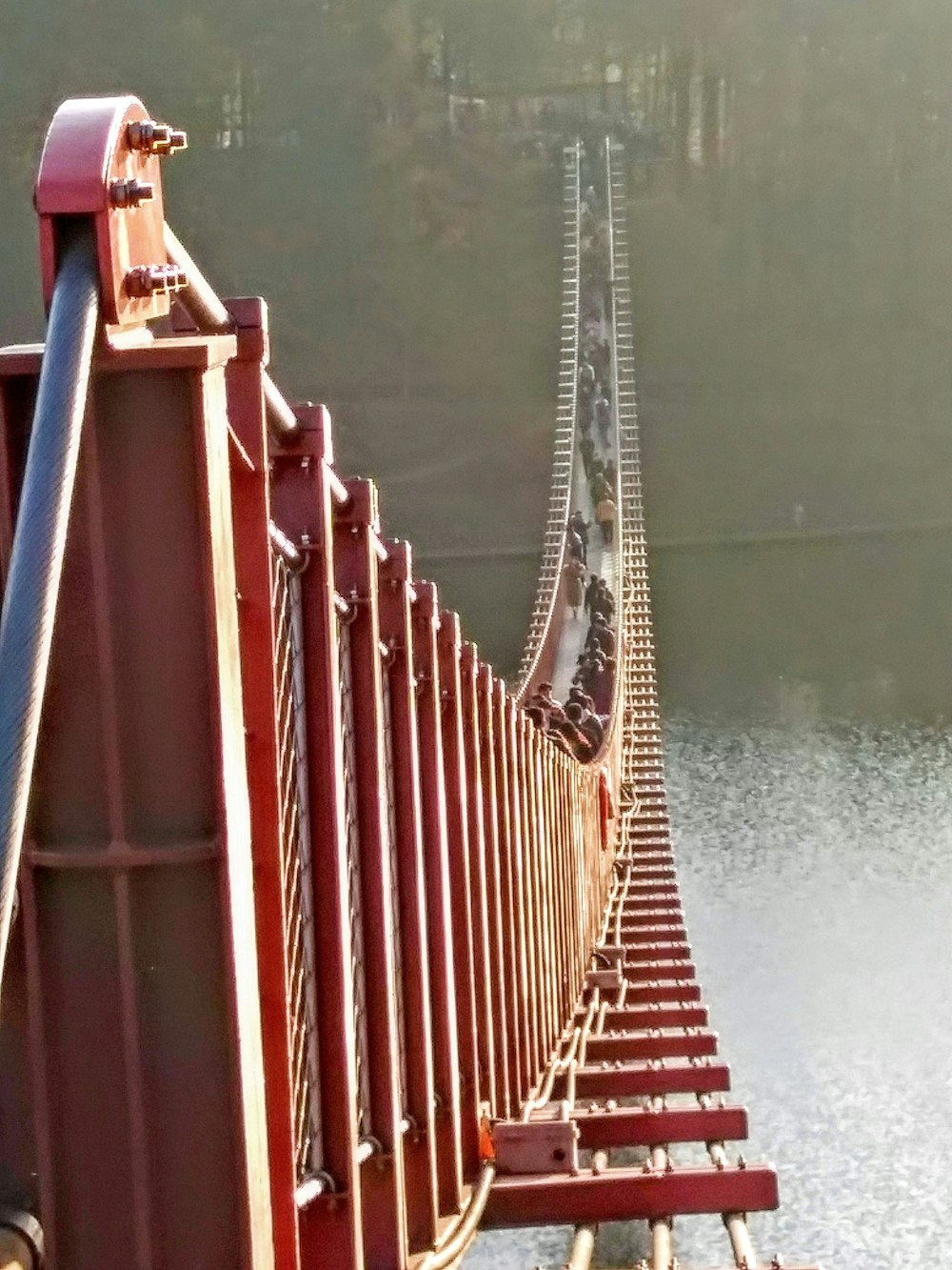 a long red bridge spanning over a body of water