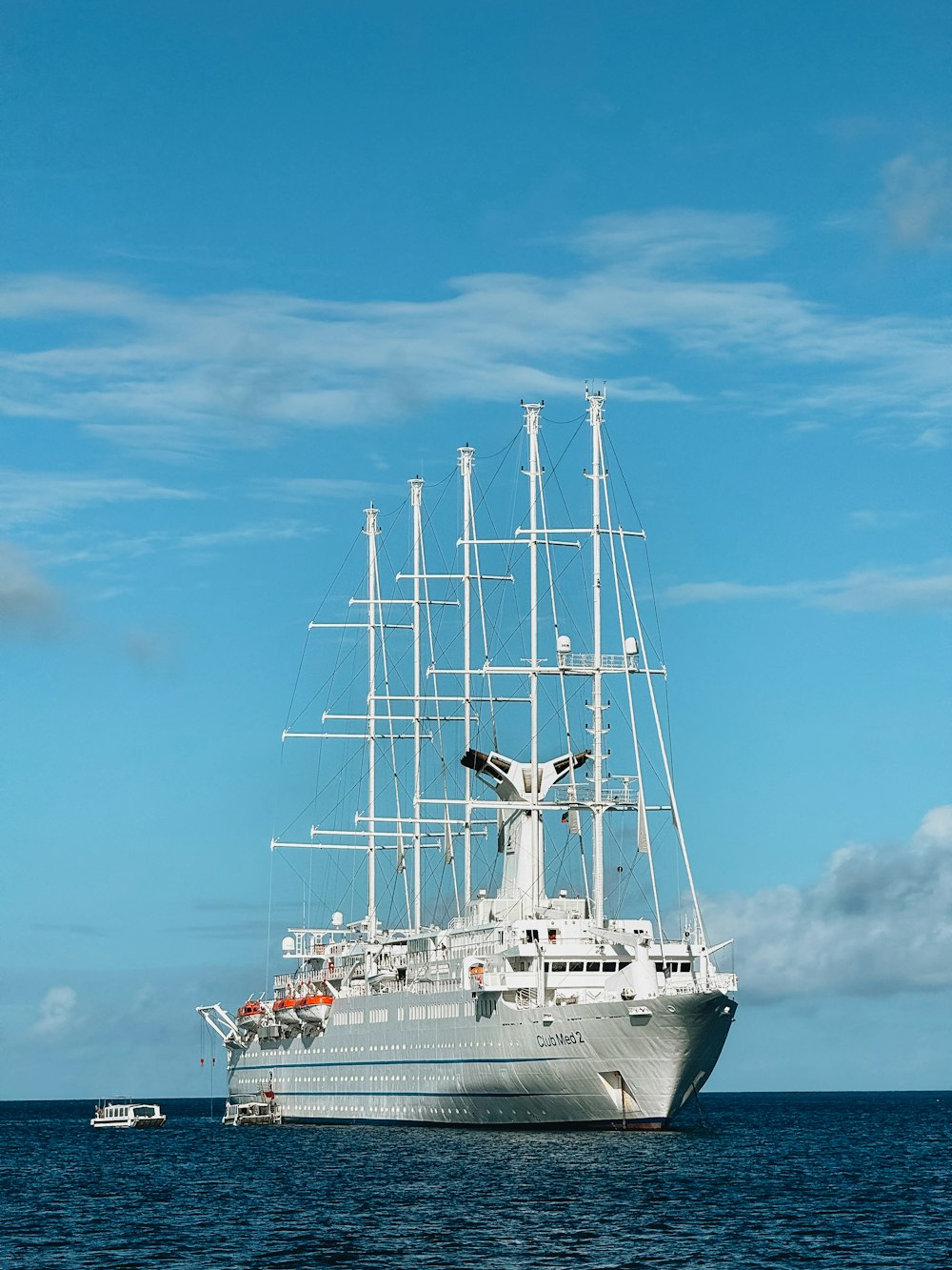 a large white ship floating on top of a body of water