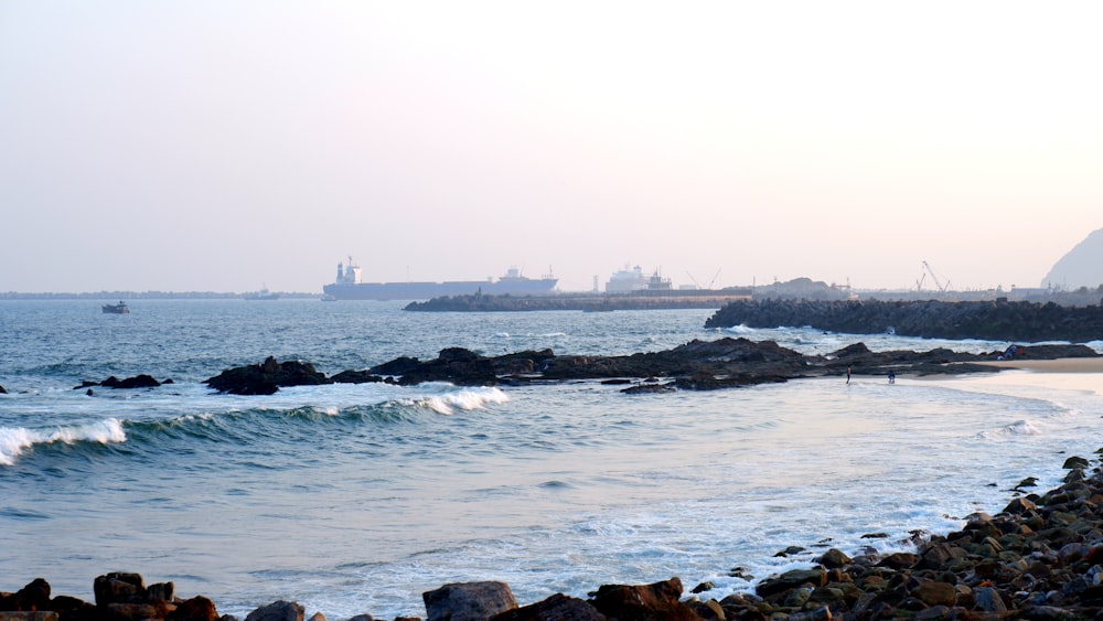 a body of water next to a rocky shore