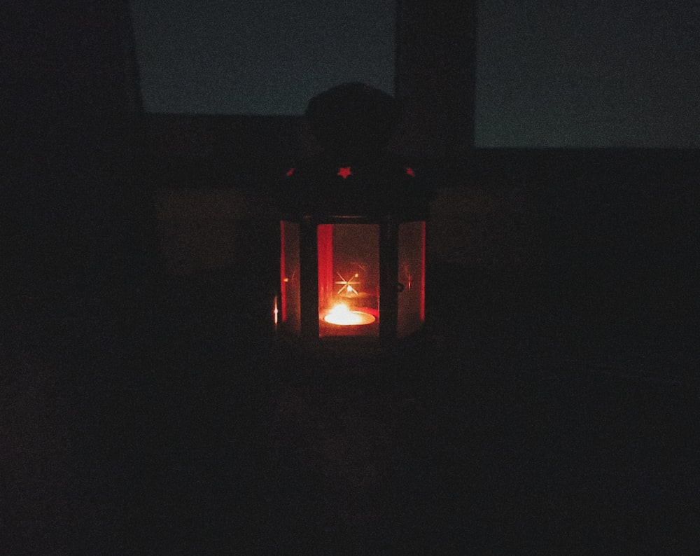 a lantern lit up in the dark at night