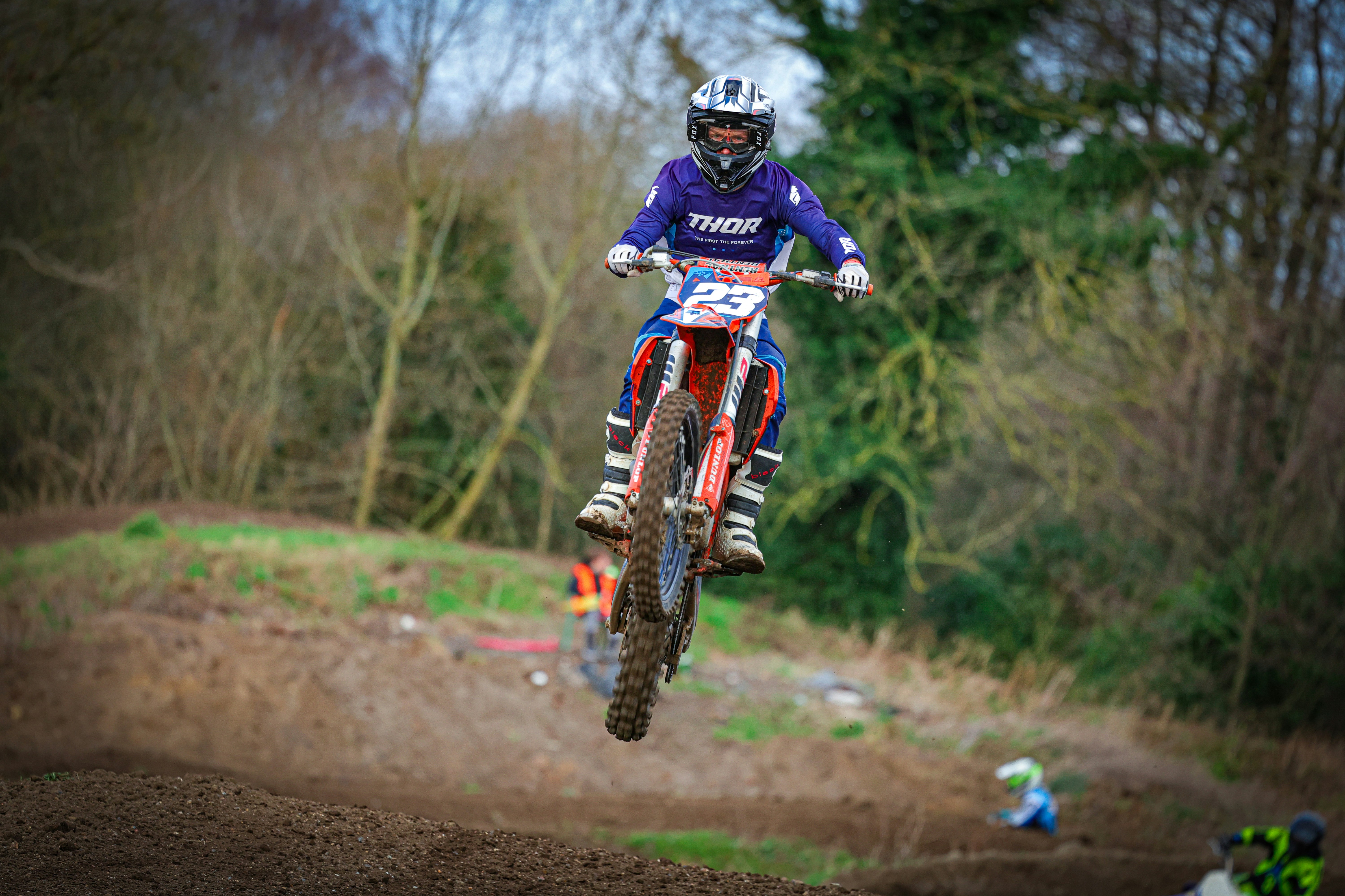 a man riding a dirt bike on top of a dirt field