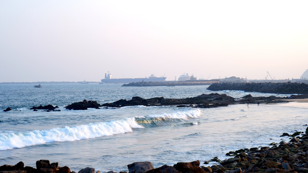 a large body of water next to a rocky shore