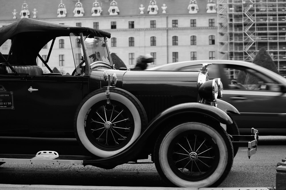 a black and white photo of an old car