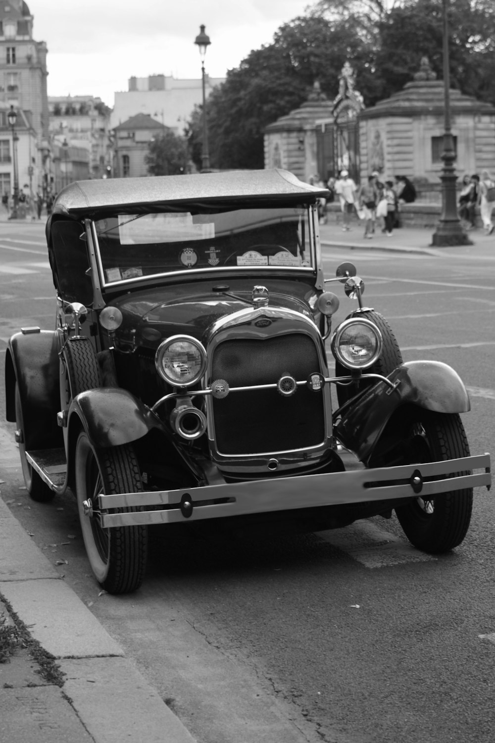 a black and white photo of an old car