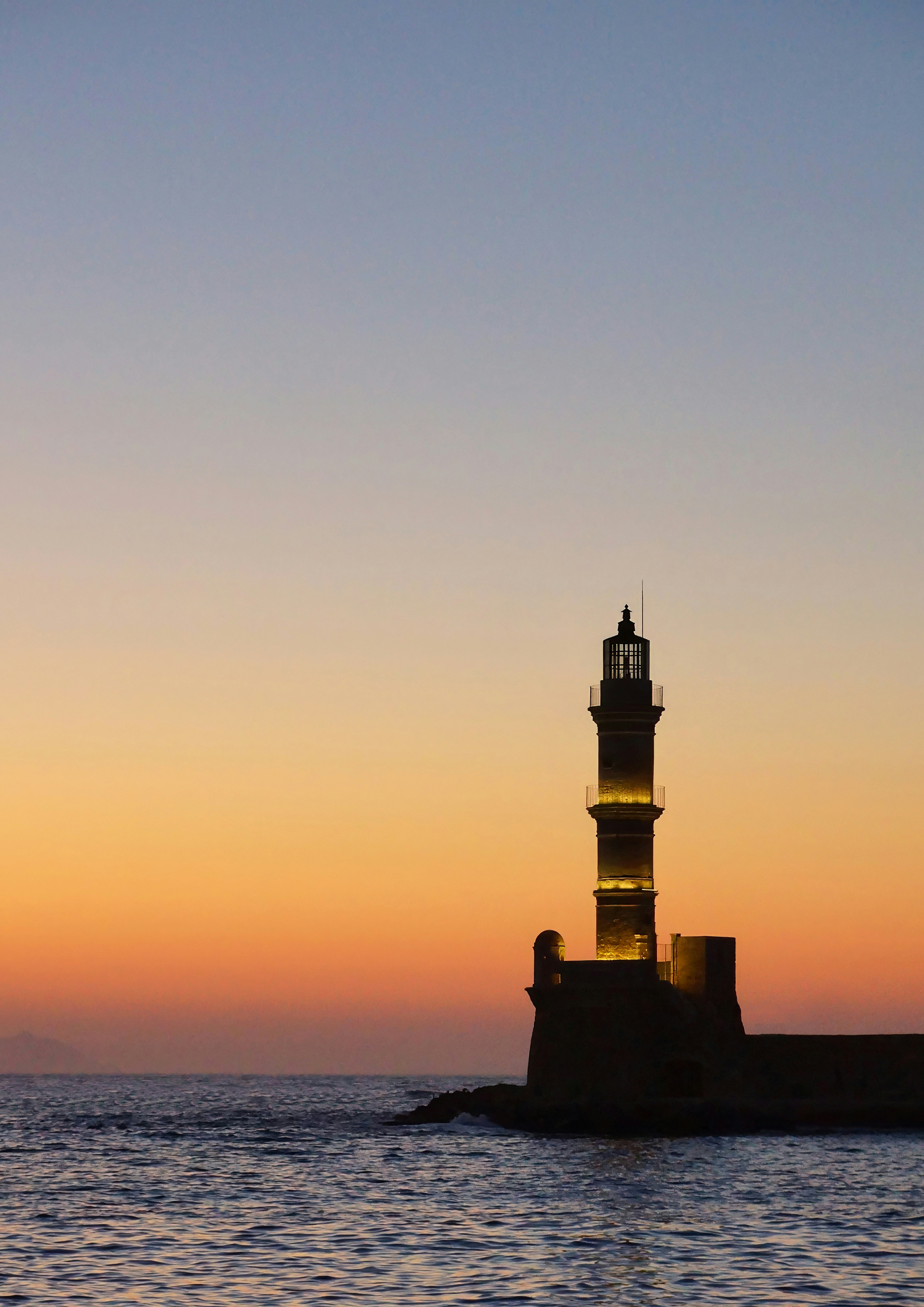 A light house sitting in the middle of a body of water