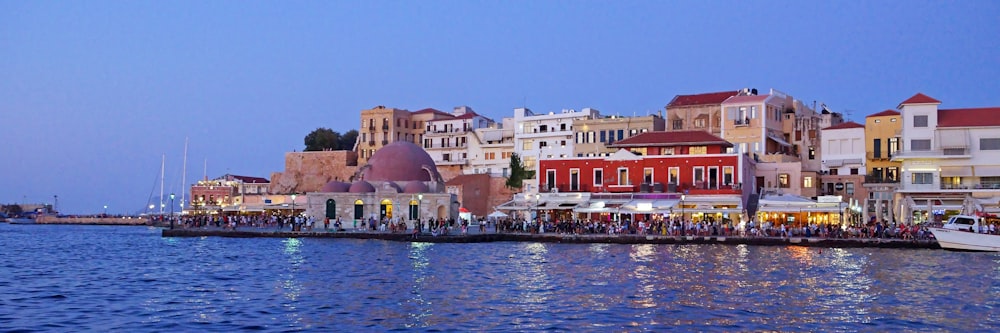 a harbor filled with lots of boats next to tall buildings