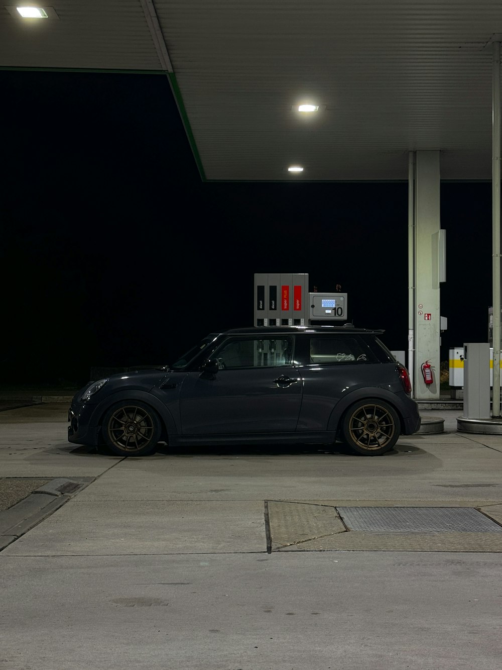a car parked at a gas station at night