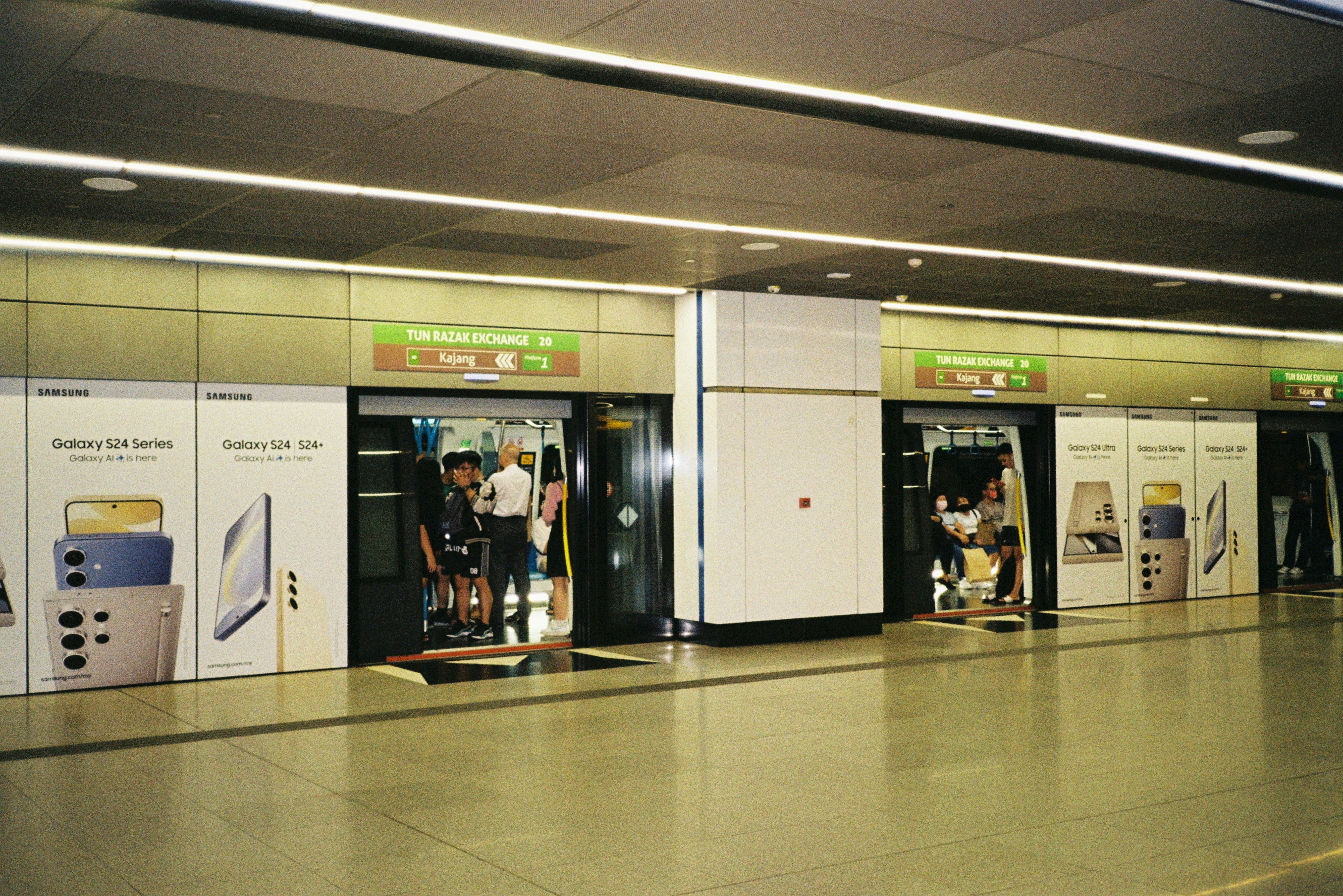 a group of people standing inside of a train station