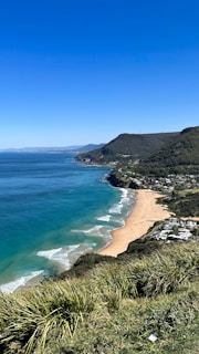 a view of a beach and the ocean from a hill