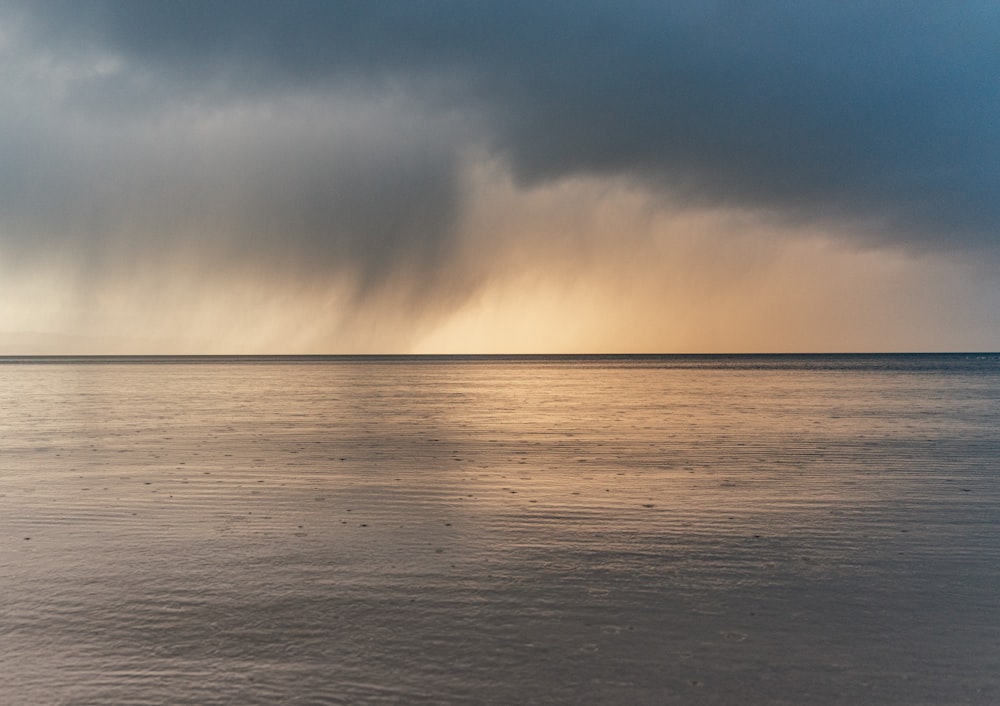 a large body of water under a cloudy sky