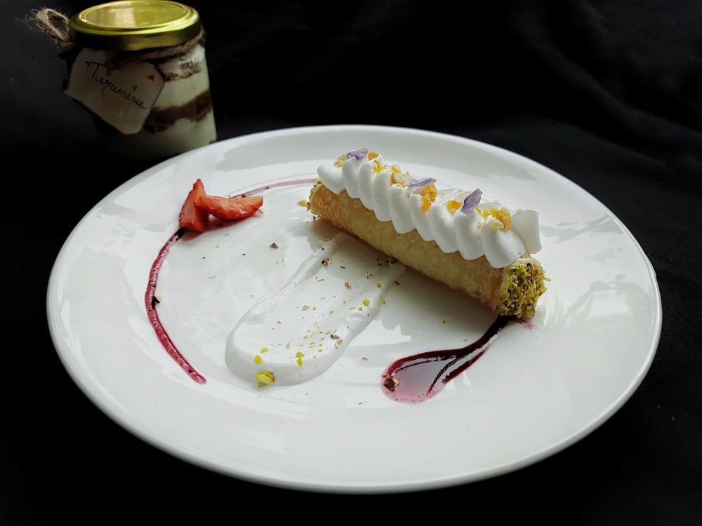 a white plate topped with a piece of cake