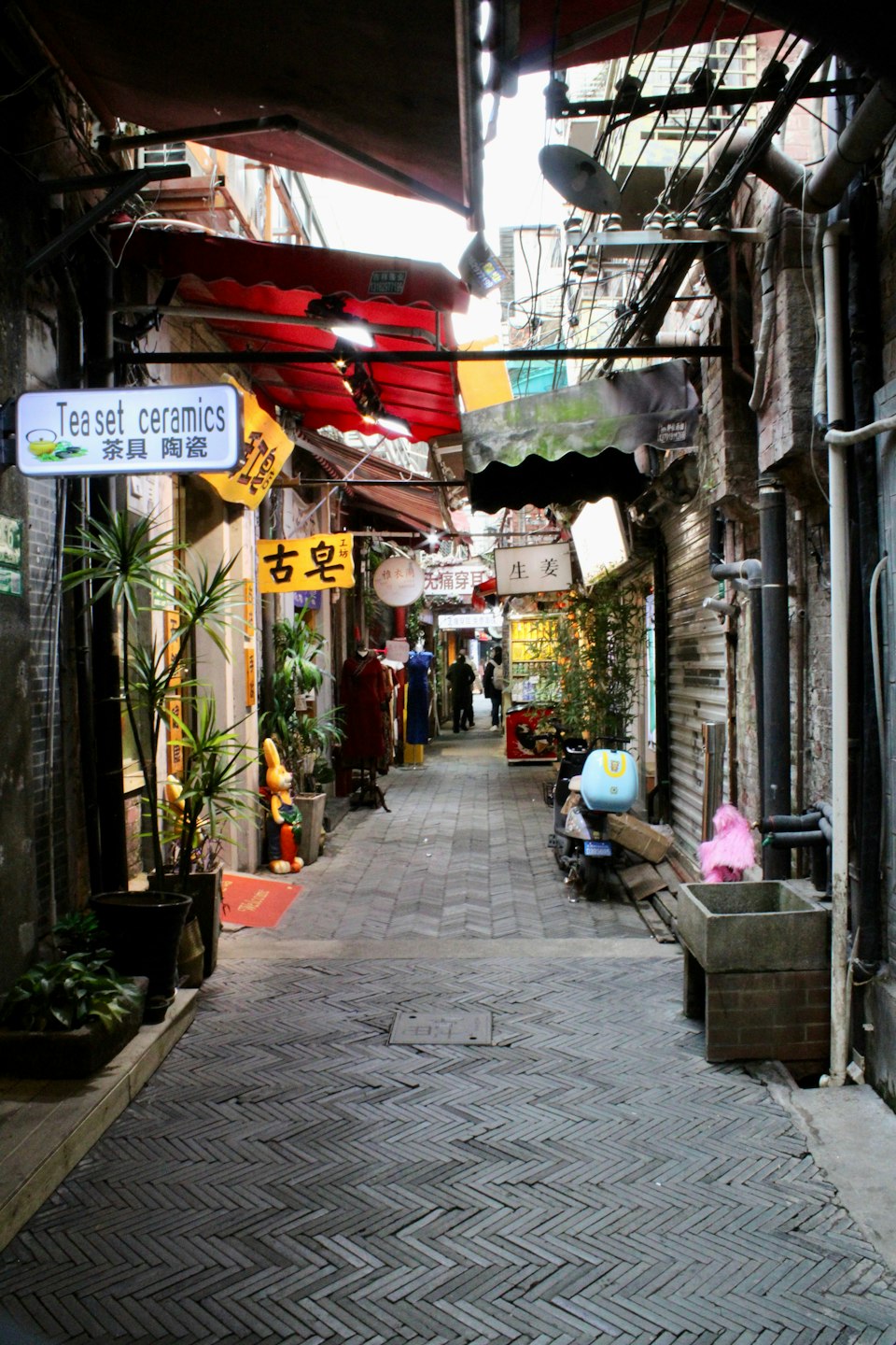 A narrow alley lined with shop signs in Tianzifang, Shanghai