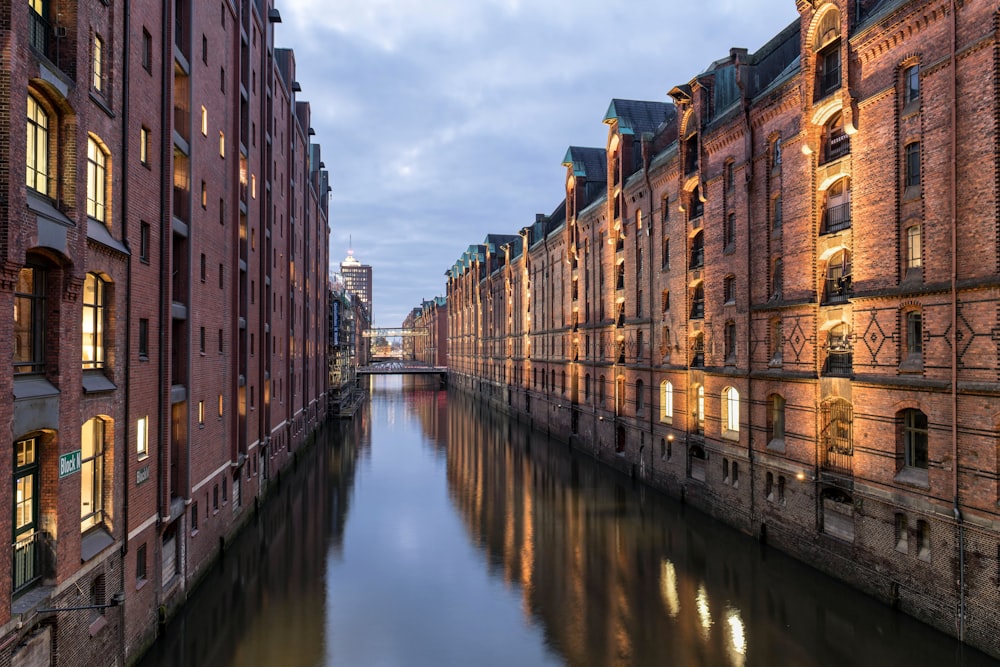 a river running through a city next to tall buildings