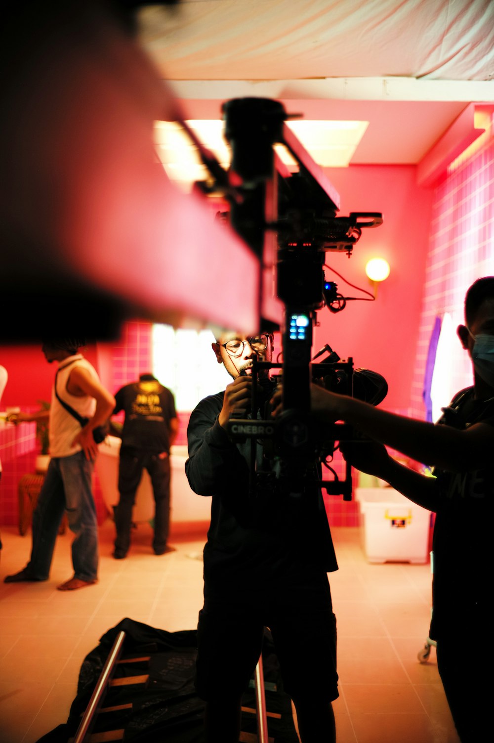 a man holding a camera in front of a group of people