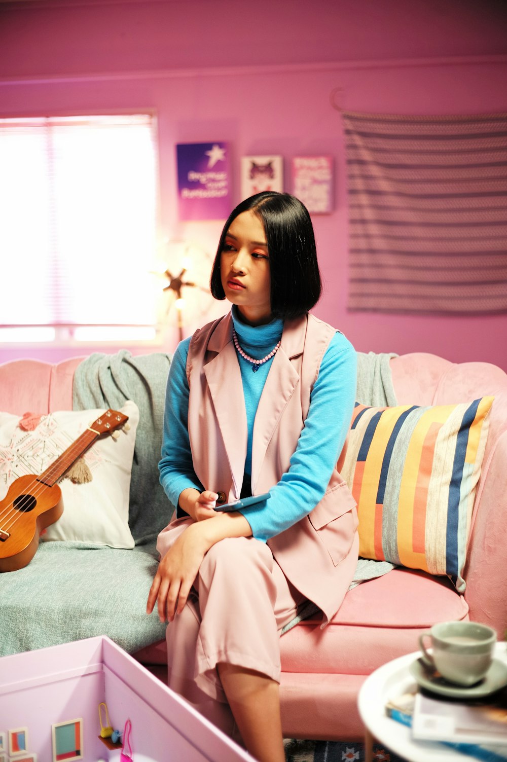 a woman sitting on a couch with a guitar