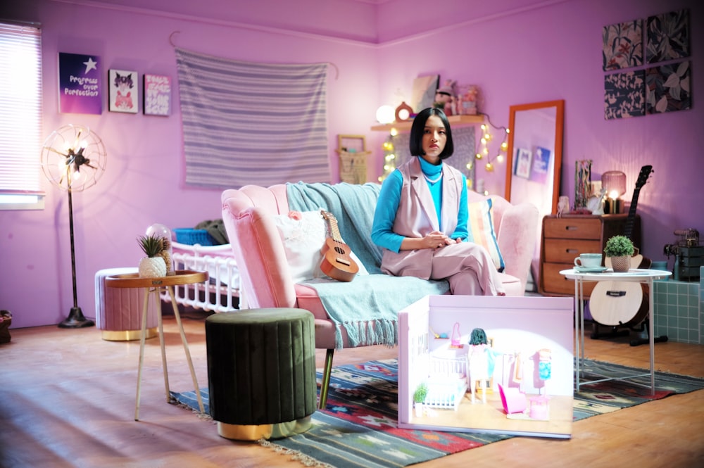 a woman sitting on a couch in a room