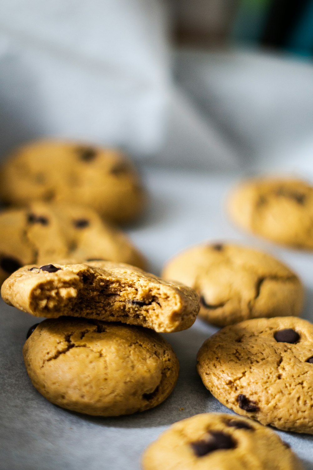 a close up of chocolate chip cookies on a baking sheet