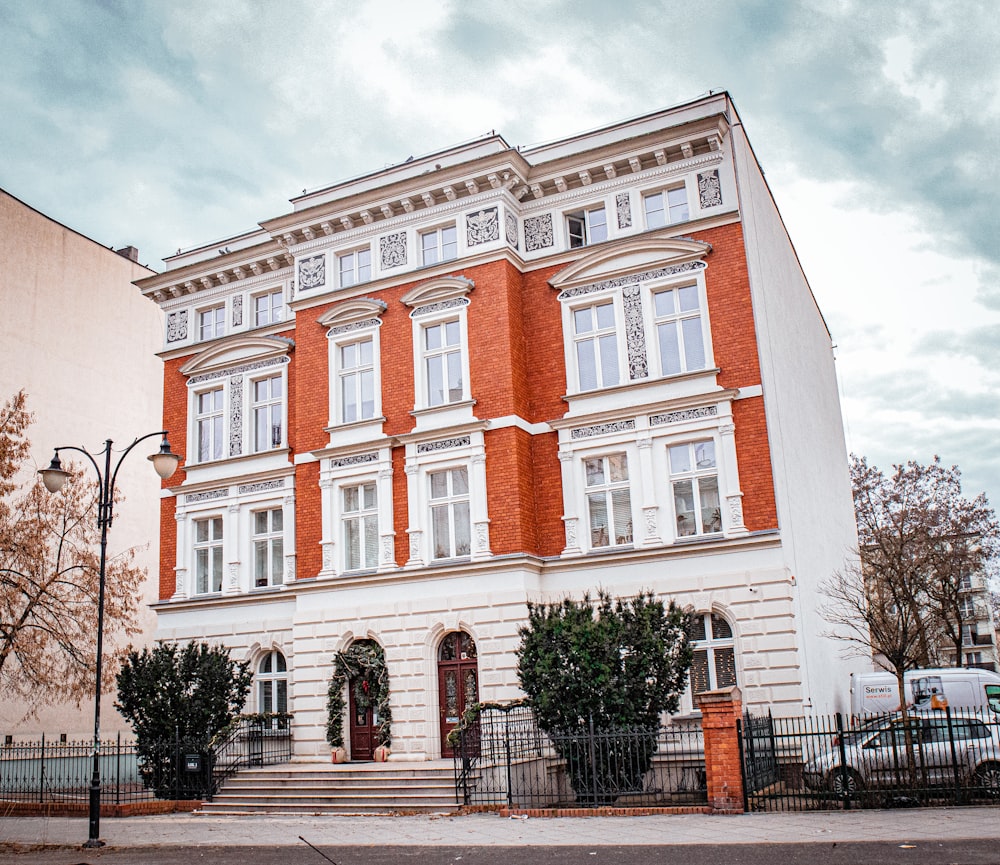 a red and white building with a clock on the front of it