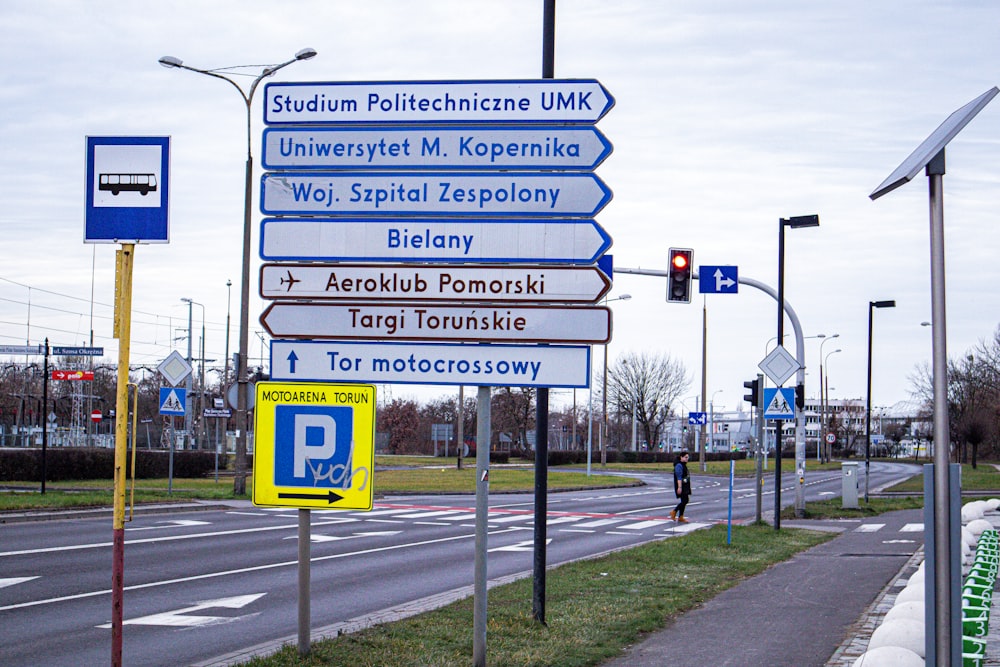 a bunch of street signs on the side of the road