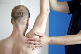 a man getting his arm examined by a doctor