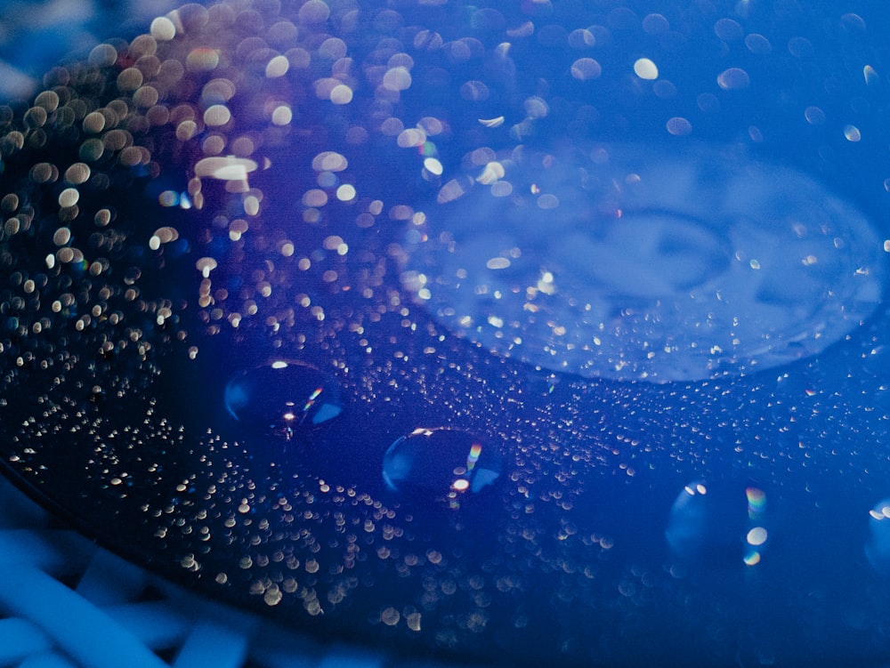 a close up of water droplets on a blue surface